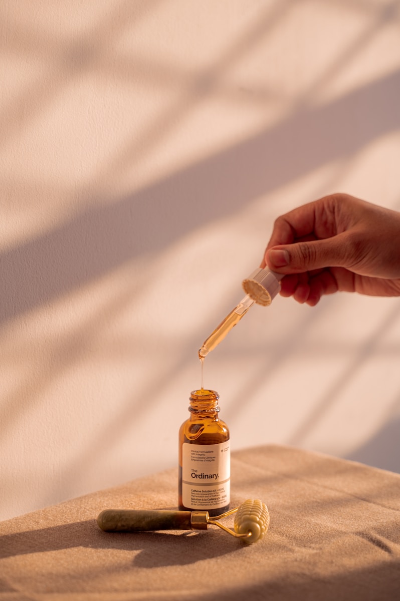 Serum is being poured from a dropper bottle.