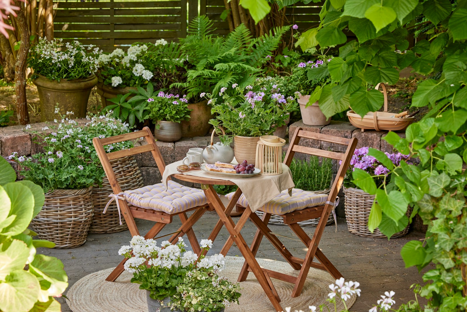 Cozy garden nook with table and chairs.